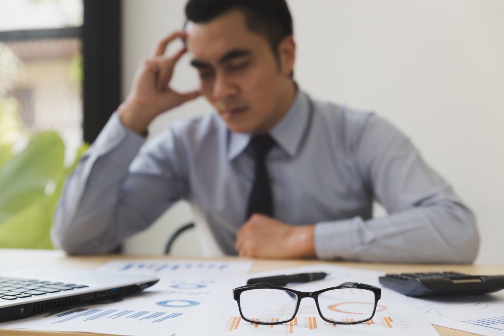 Professional thinking over data charts in an office environment